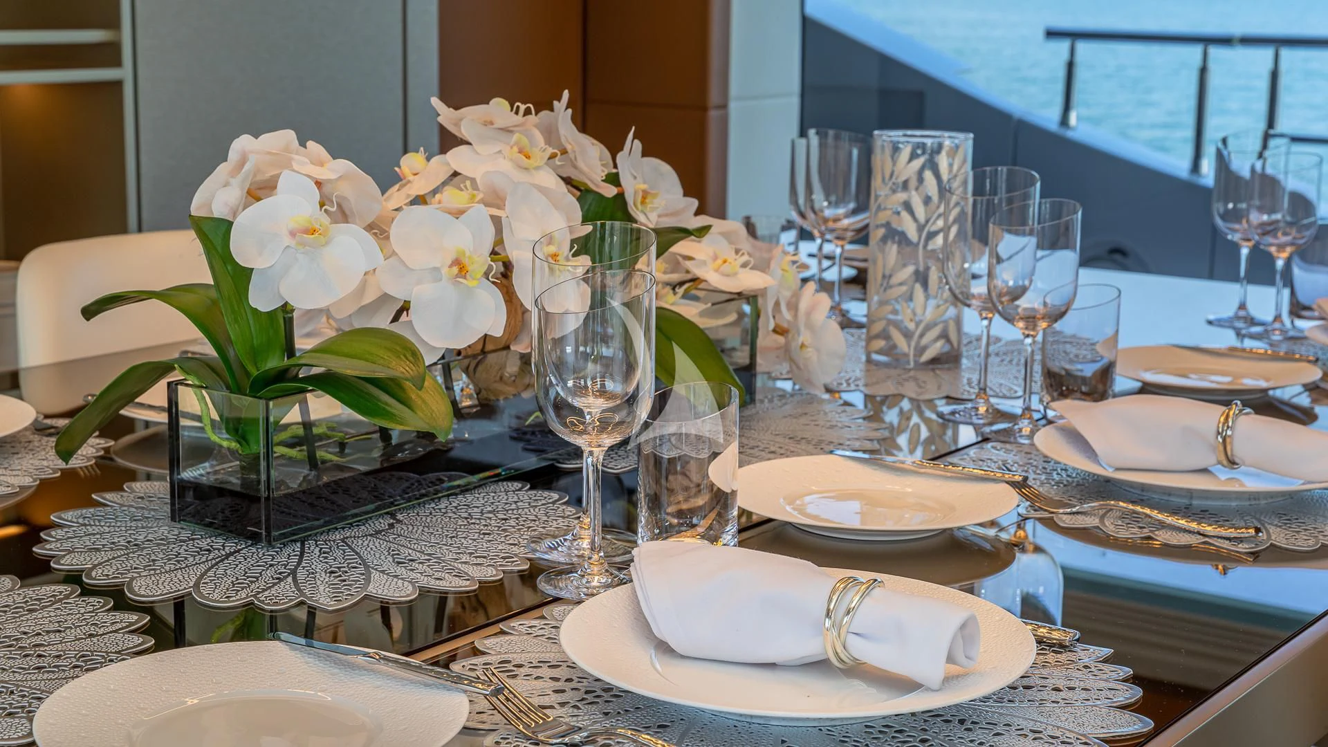 a table set with plates and glasses aboard RISING DAWN Yacht for Sale