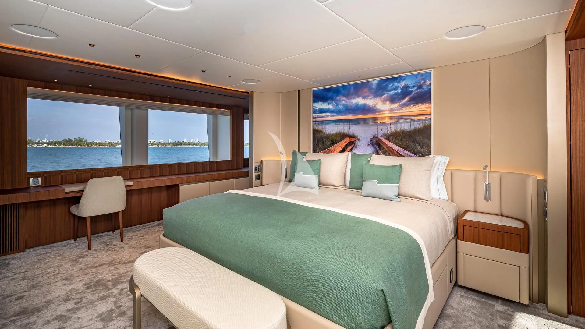 a room with a bed and a chair aboard RISING DAWN Yacht for Sale