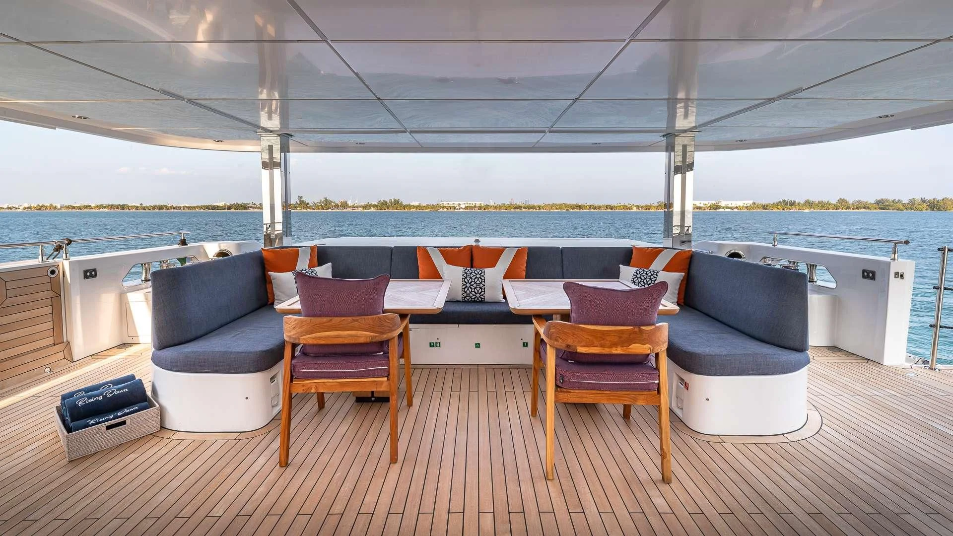 a deck with chairs and a table aboard RISING DAWN Yacht for Sale