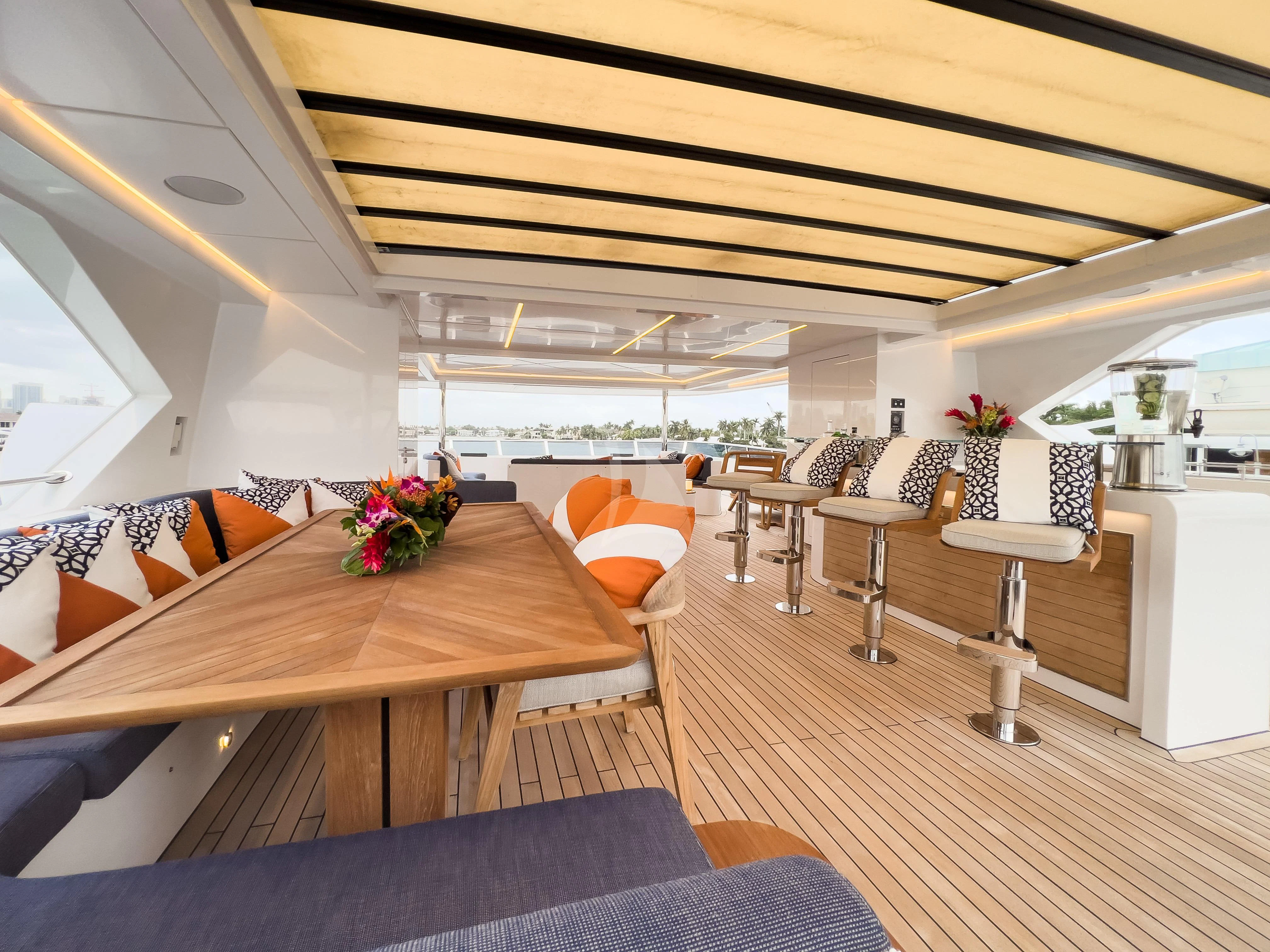 a room with tables and chairs aboard RISING DAWN Yacht for Sale