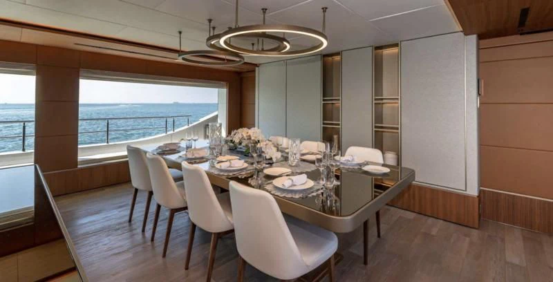 a dining table in a room aboard RISING DAWN Yacht for Sale