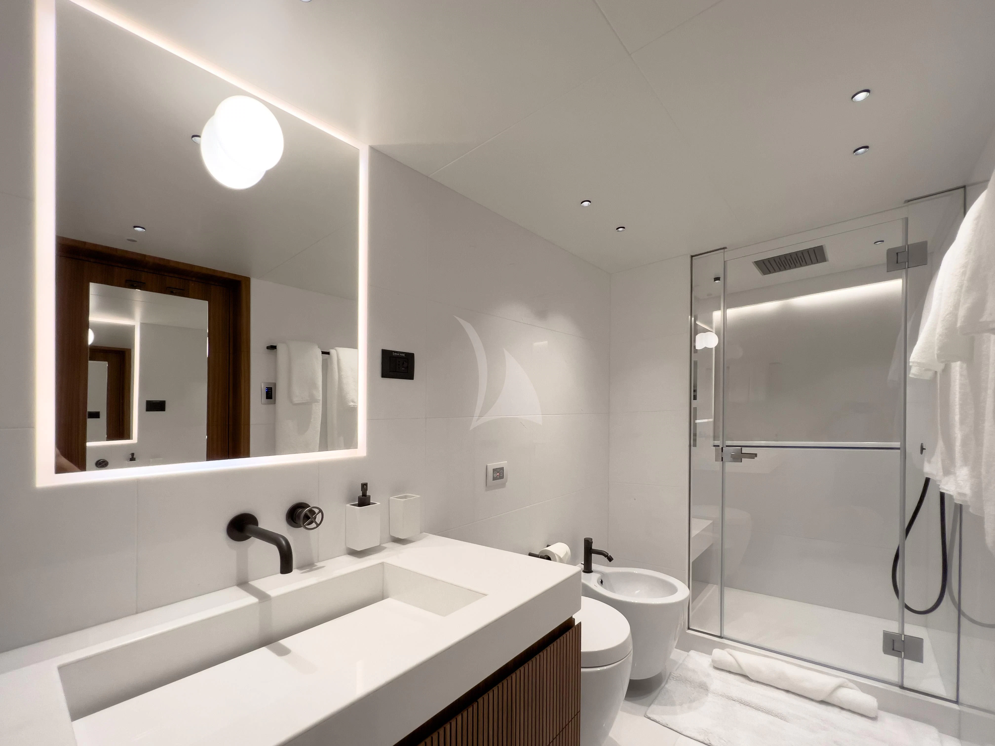 a bathroom with a glass shower aboard RISING DAWN Yacht for Sale