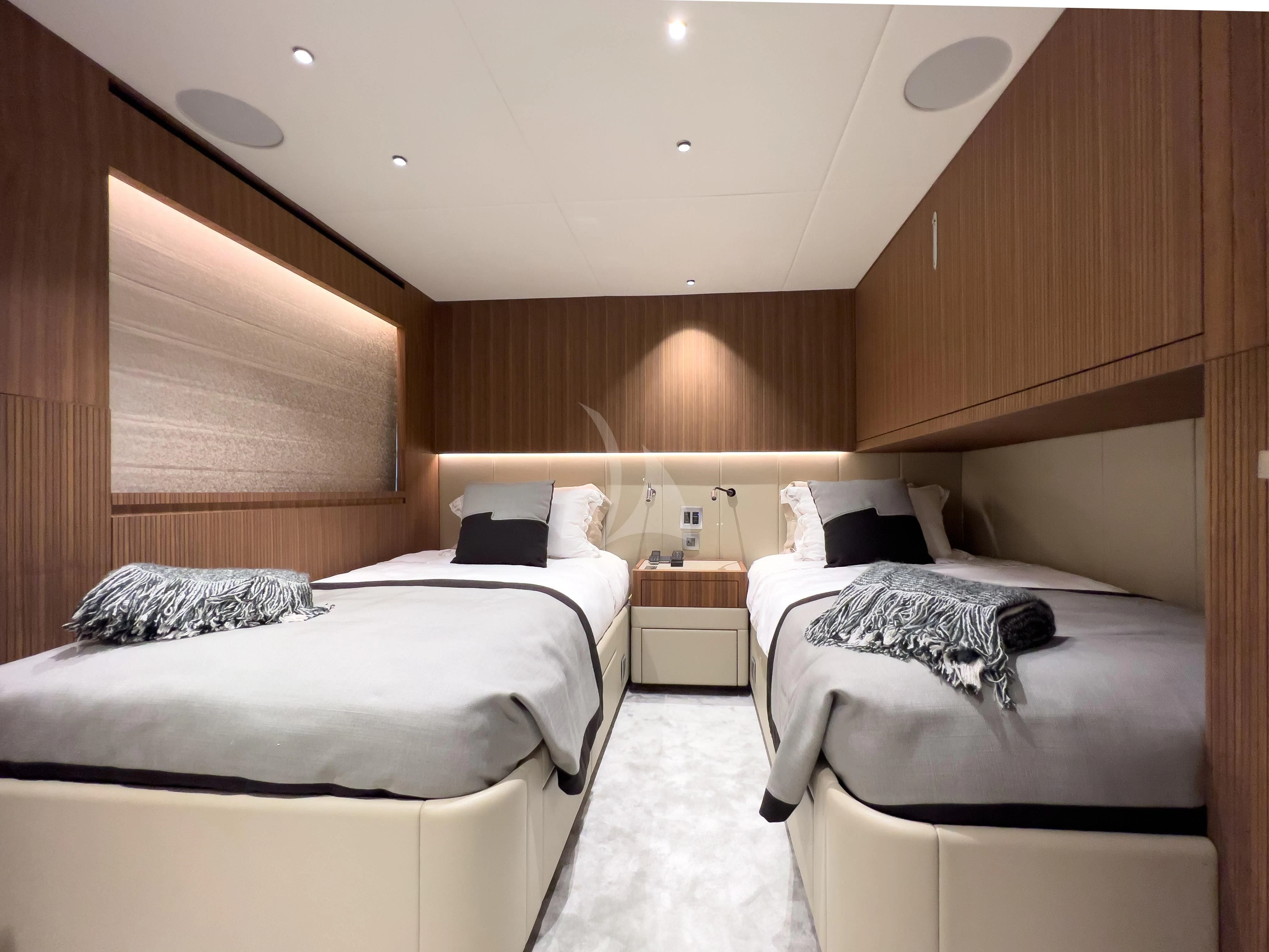 a room with beds and a table aboard RISING DAWN Yacht for Sale