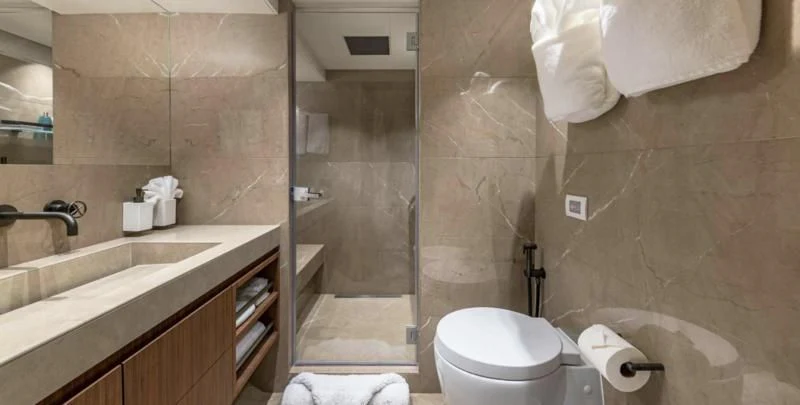 a bathroom with a glass shower aboard RISING DAWN Yacht for Sale