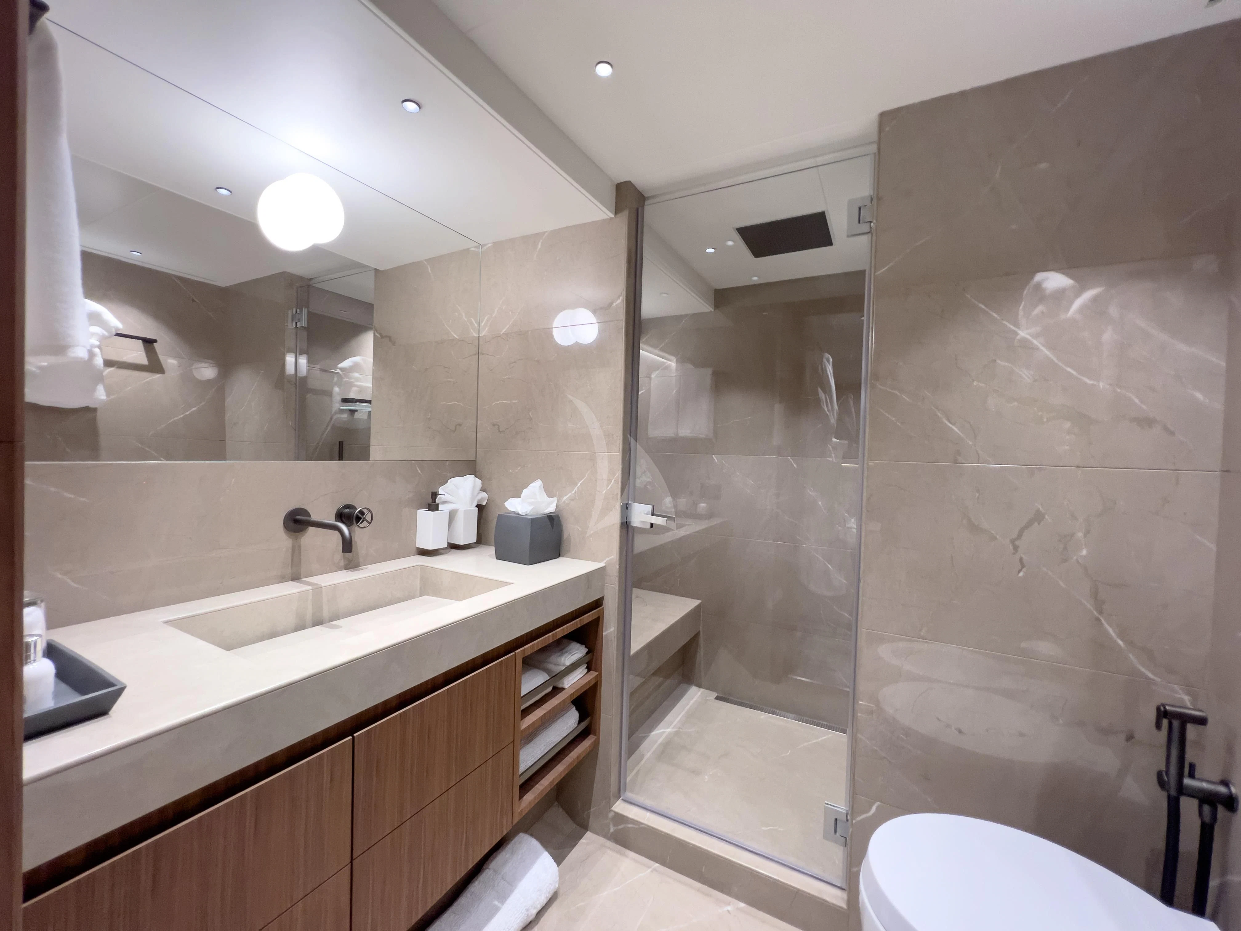 a bathroom with a glass shower aboard RISING DAWN Yacht for Sale