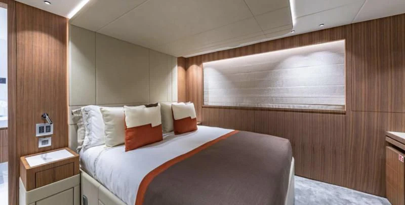 a room with a bed and a wood wall aboard RISING DAWN Yacht for Sale