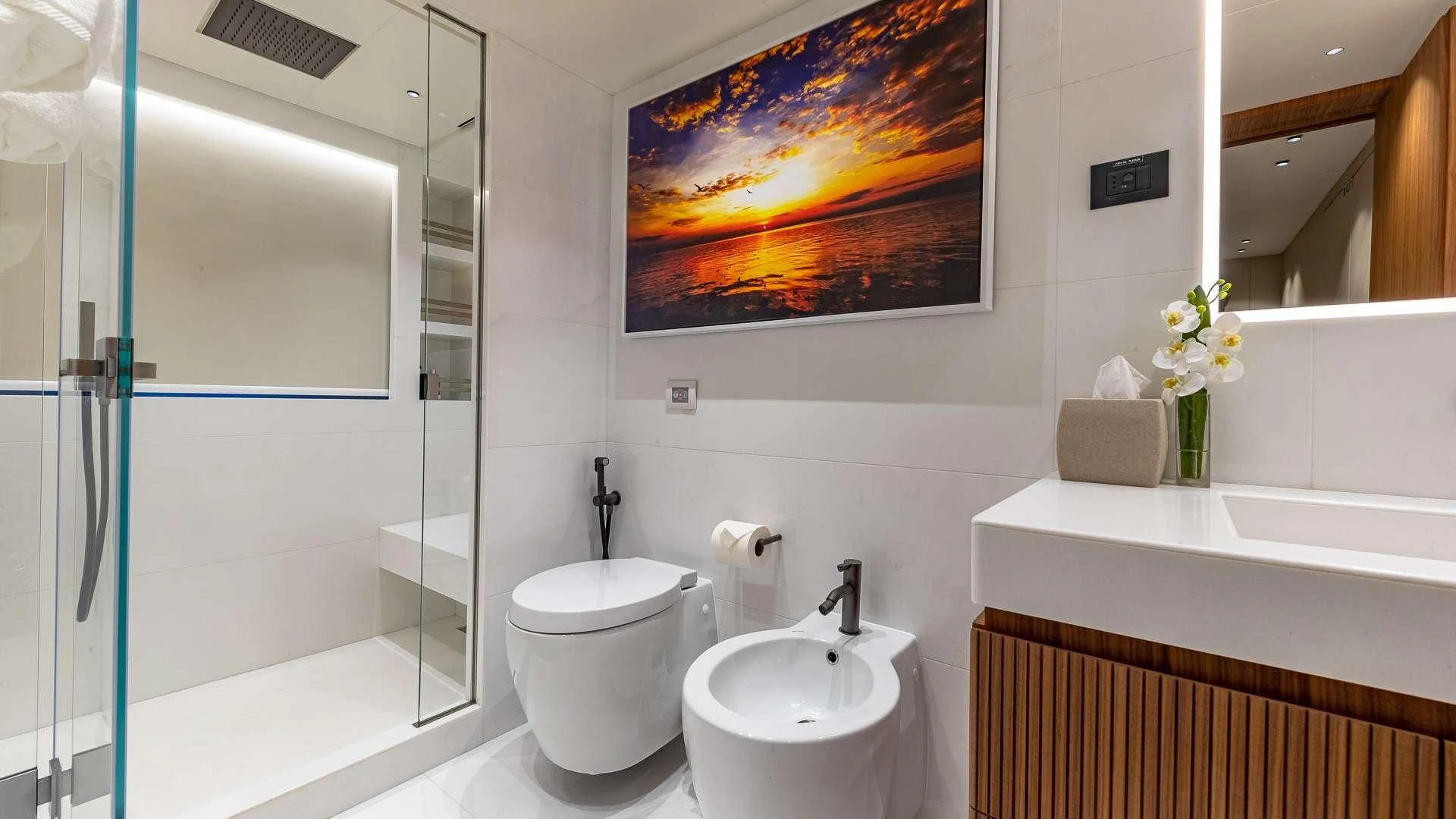 a bathroom with a glass shower aboard RISING DAWN Yacht for Sale