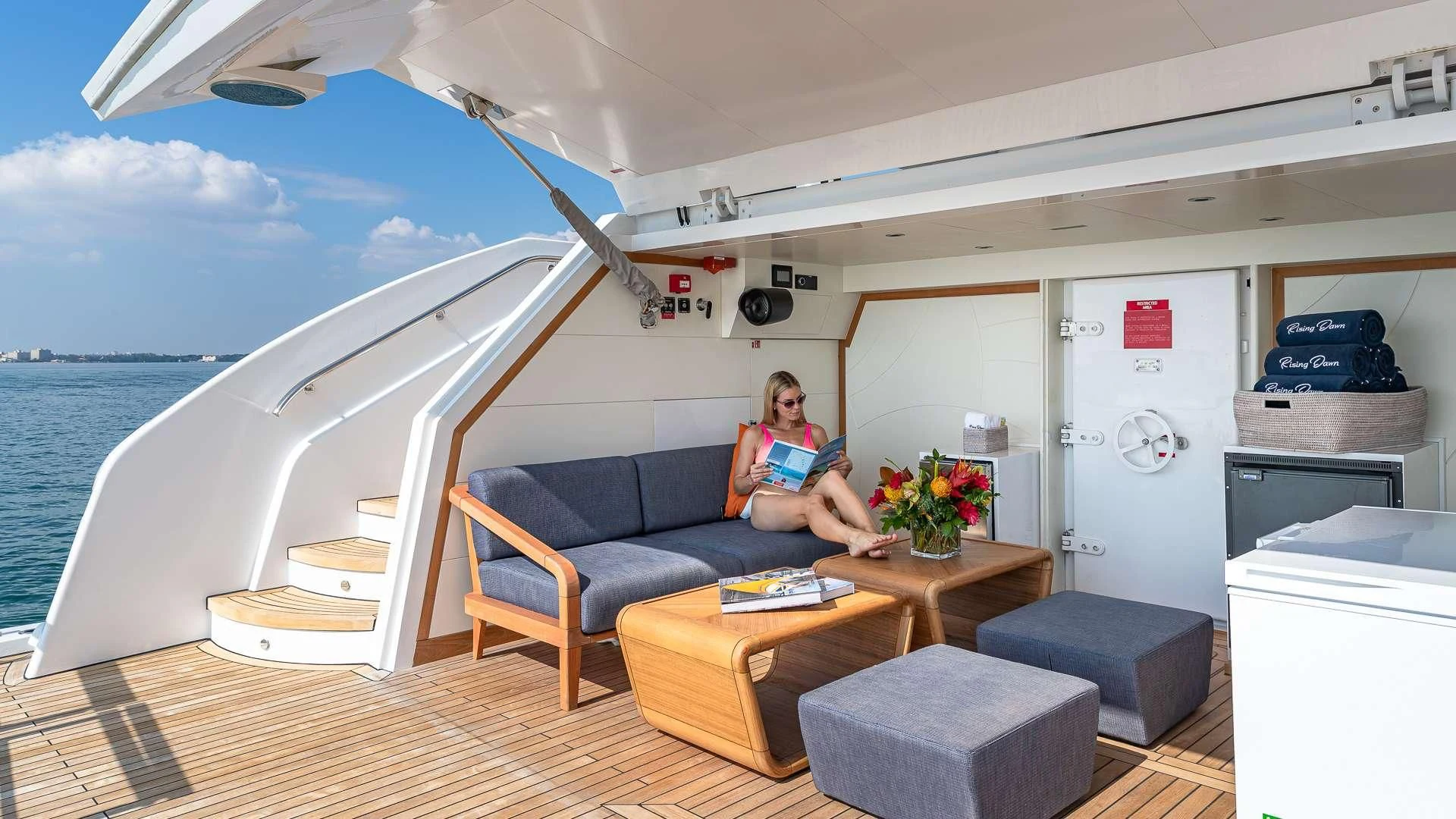 a person sitting on a couch on a boat aboard RISING DAWN Yacht for Sale