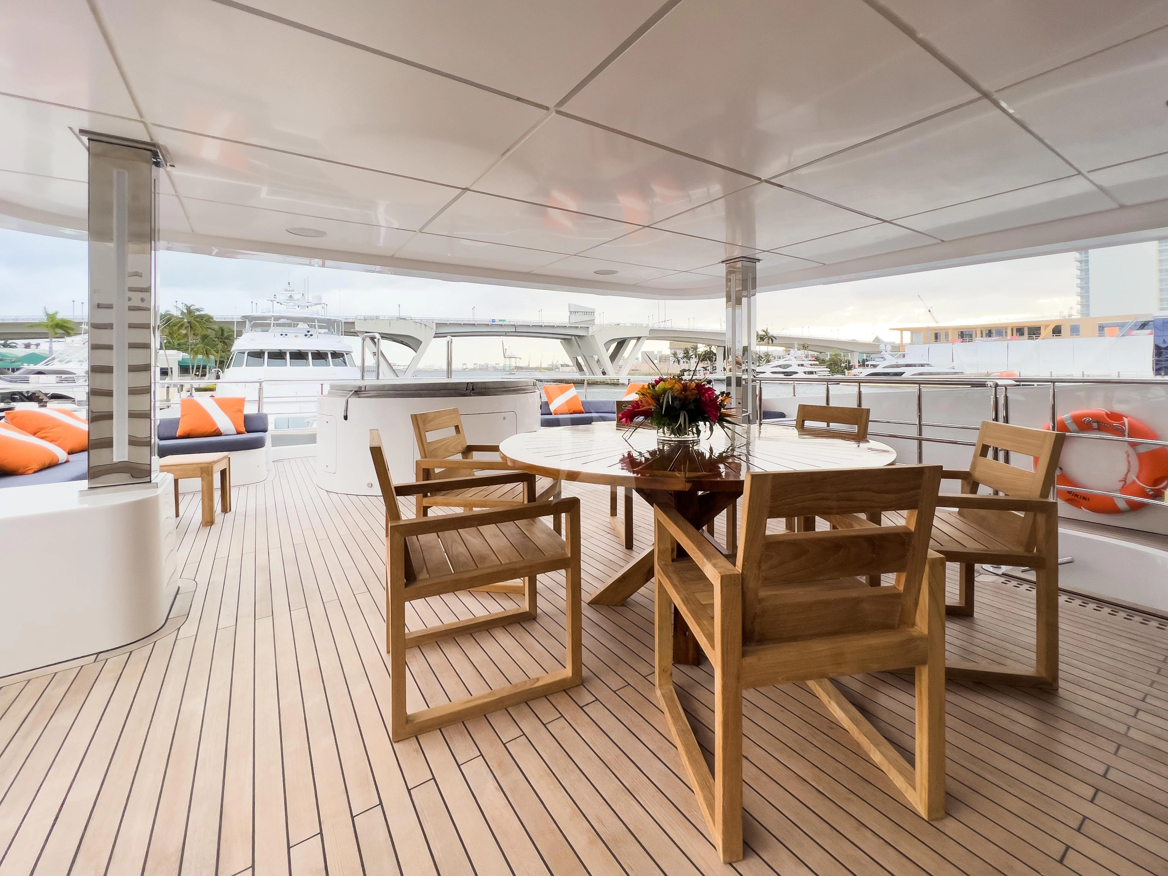 a room with tables and chairs aboard RISING DAWN Yacht for Sale