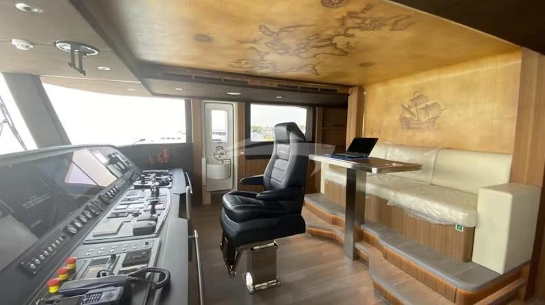 inside of a vehicle with a desk and chairs aboard RISING DAWN Yacht for Sale