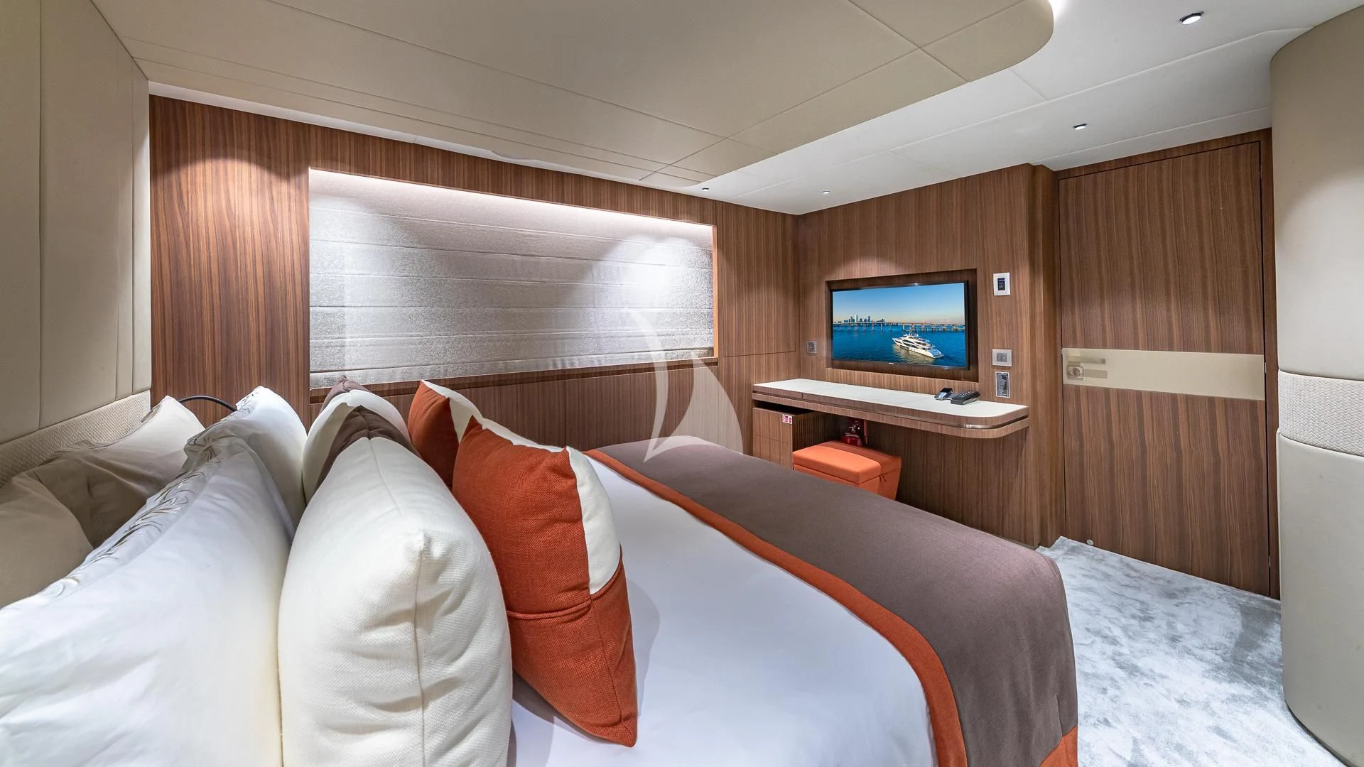 a bed with a television on the wall aboard RISING DAWN Yacht for Sale