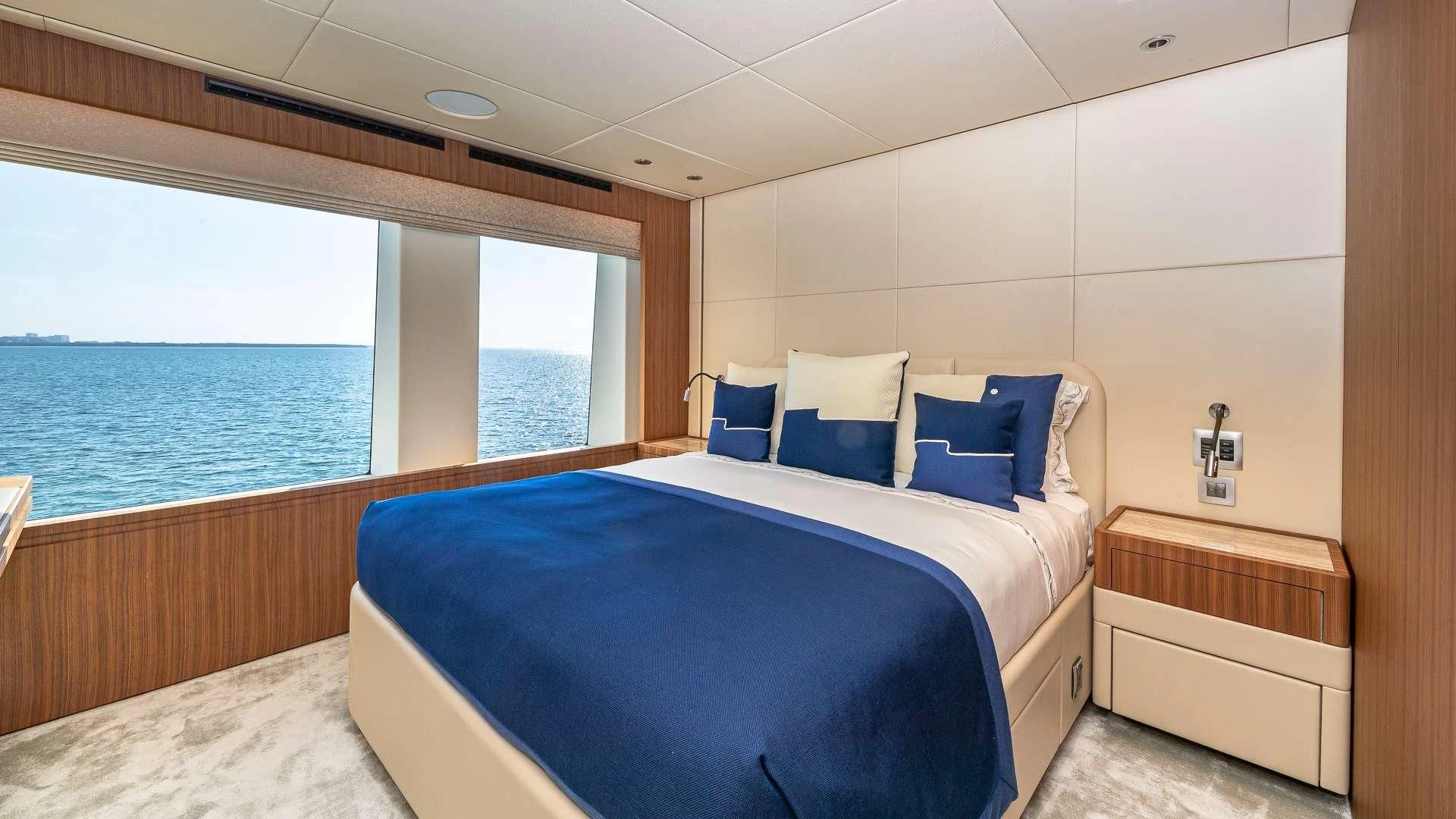a room with a bed and a window aboard RISING DAWN Yacht for Sale