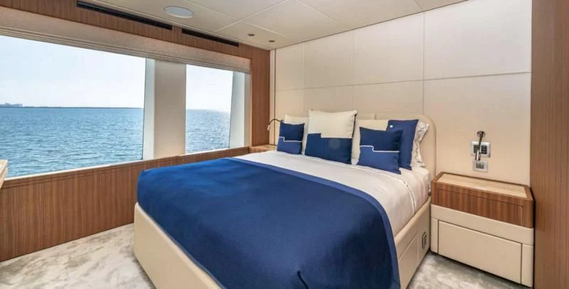 a room with a bed and a window aboard RISING DAWN Yacht for Sale
