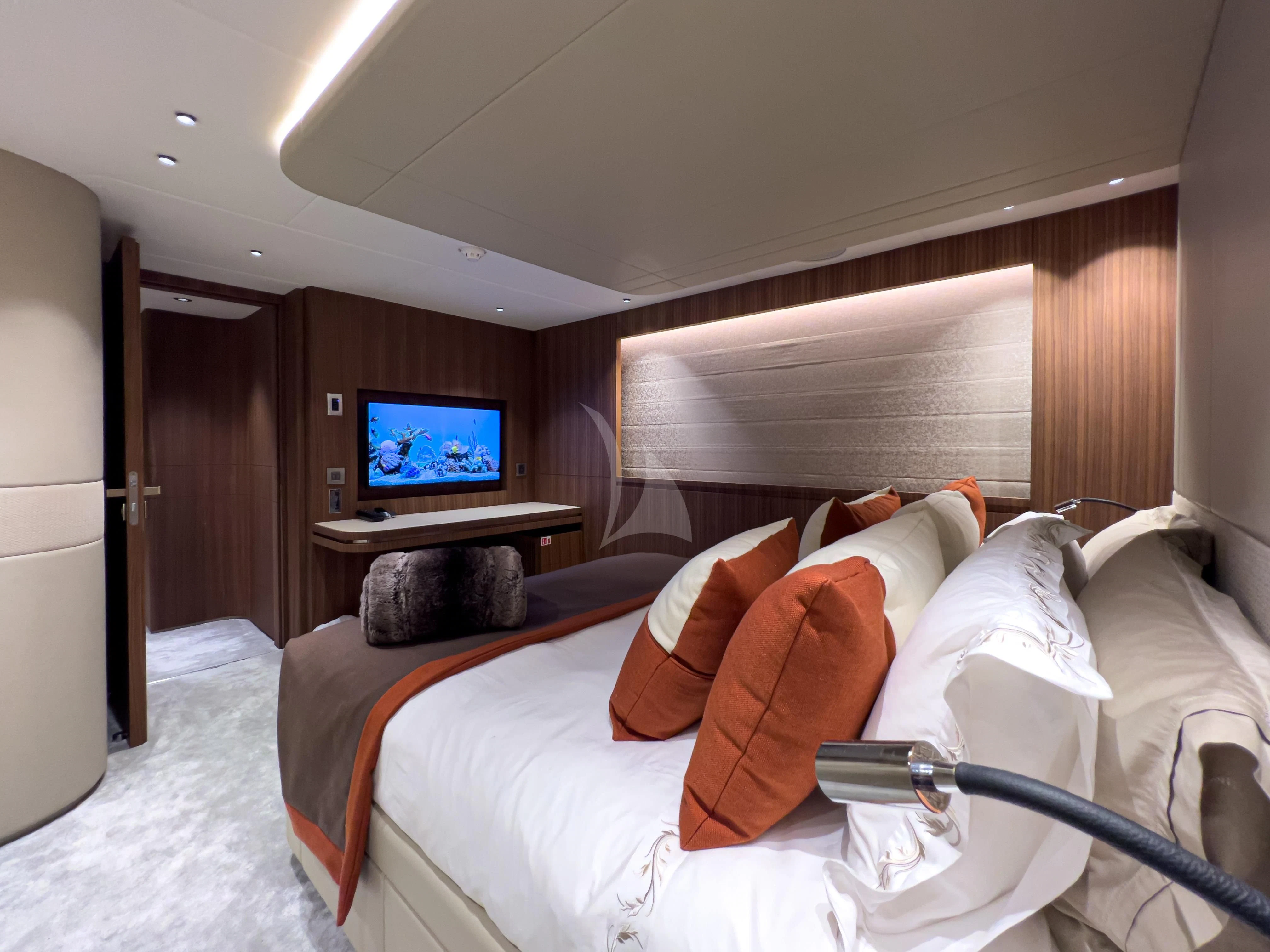 a bed with a television on the wall aboard RISING DAWN Yacht for Sale