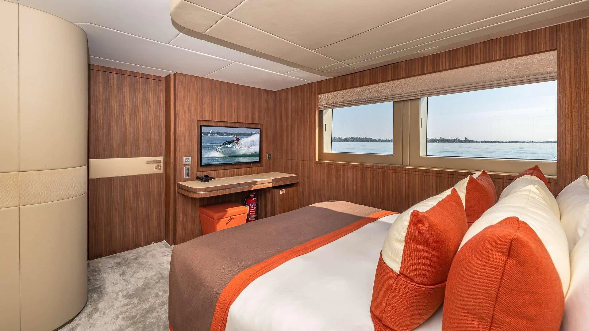 a bedroom with a bed and a television aboard RISING DAWN Yacht for Sale