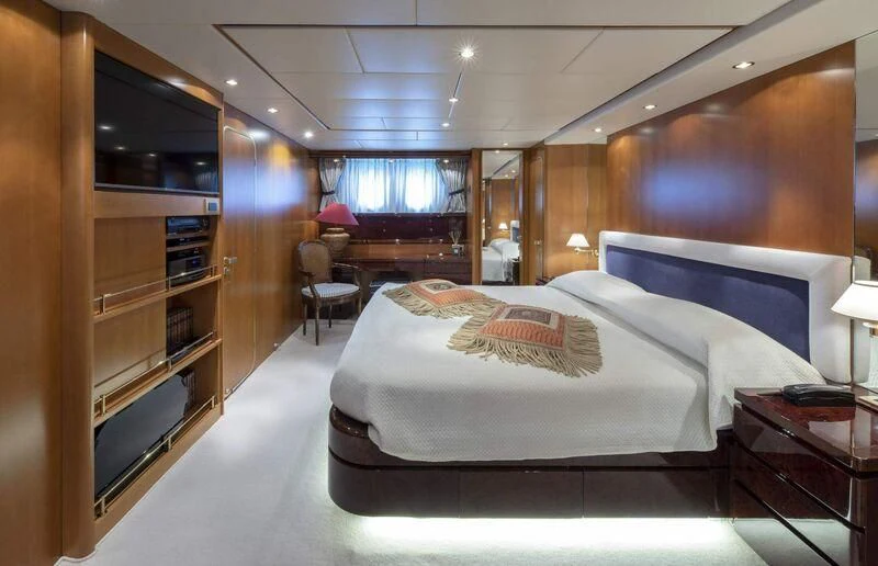 a bedroom with a bed and a tv aboard VISOTTA Yacht for Sale