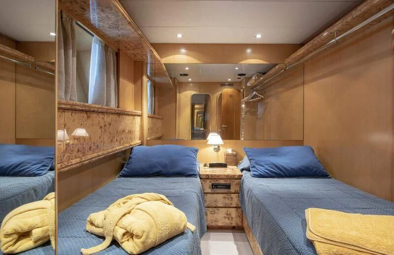 a room with a bed and a dresser aboard VISOTTA Yacht for Sale