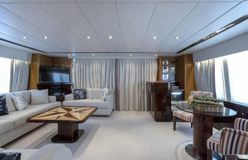 a living room with a couch and a coffee table aboard VISOTTA Yacht for Sale