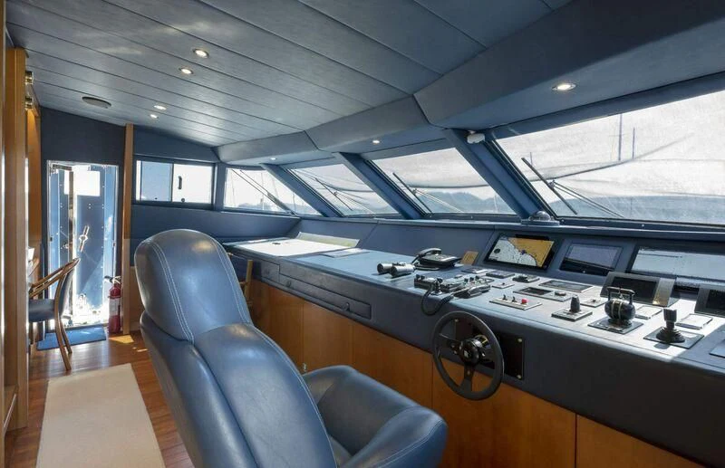 a room with a large table and computer equipment aboard VISOTTA Yacht for Sale