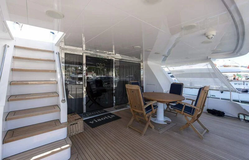 a room with a table and chairs aboard VISOTTA Yacht for Sale