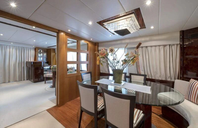 a dining room with a table and chairs aboard VISOTTA Yacht for Sale