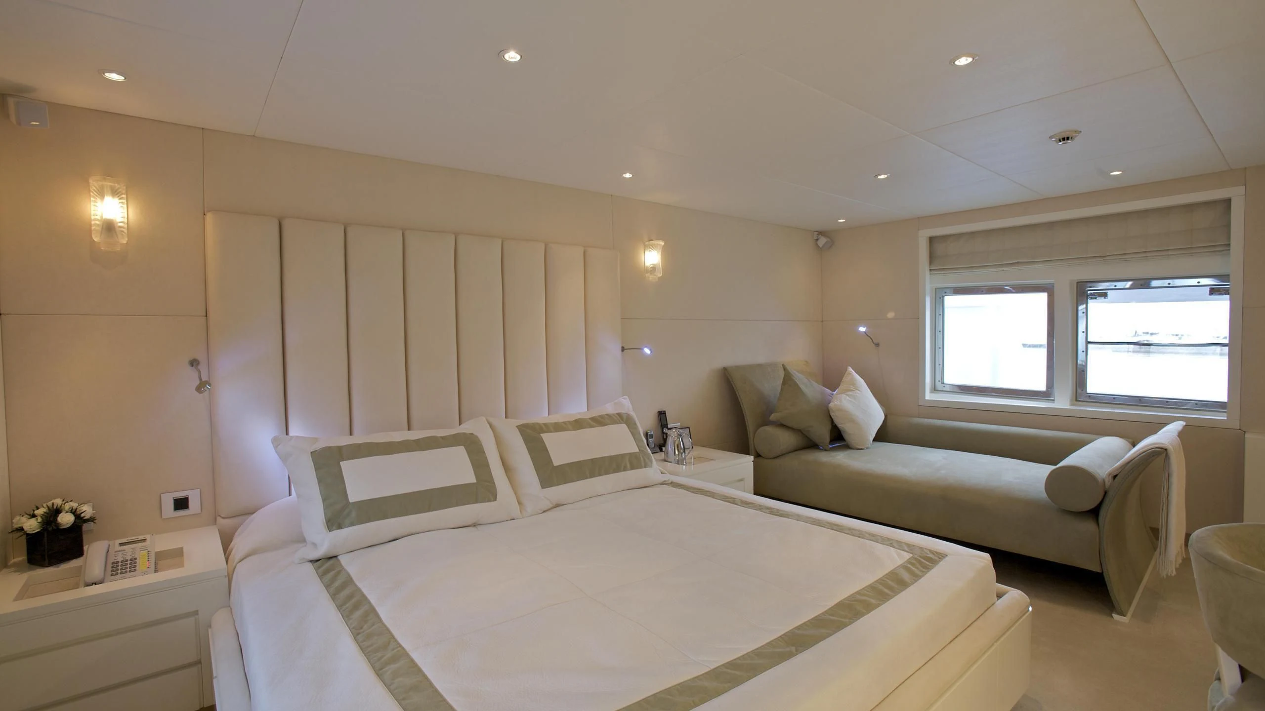 a bedroom with a bed and a couch aboard ACHILLES Yacht for Sale