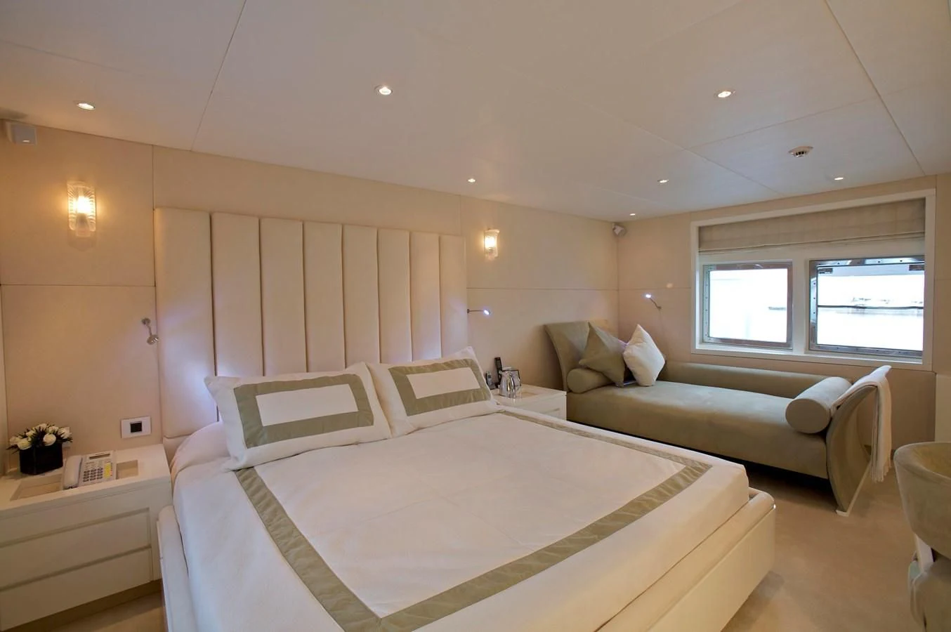 a bedroom with a bed and a couch aboard ACHILLES Yacht for Sale