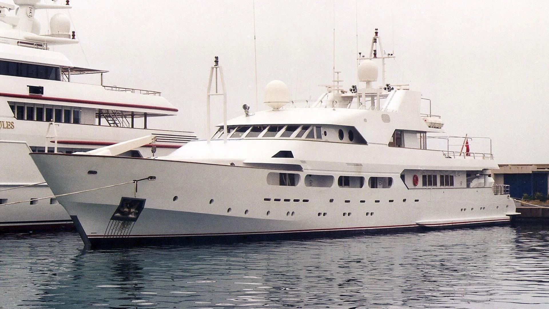 a couple of large white yachts with USS Potomac (AG-25) in the background aboard ACHILLES Yacht for Sale
