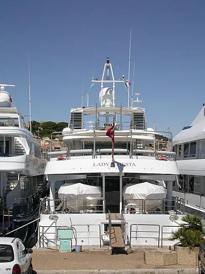 a large white boat with a flag on it aboard ACHILLES Yacht for Sale