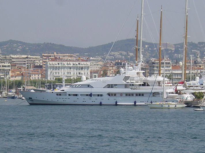 a large white boat in a harbor aboard ACHILLES Yacht for Sale