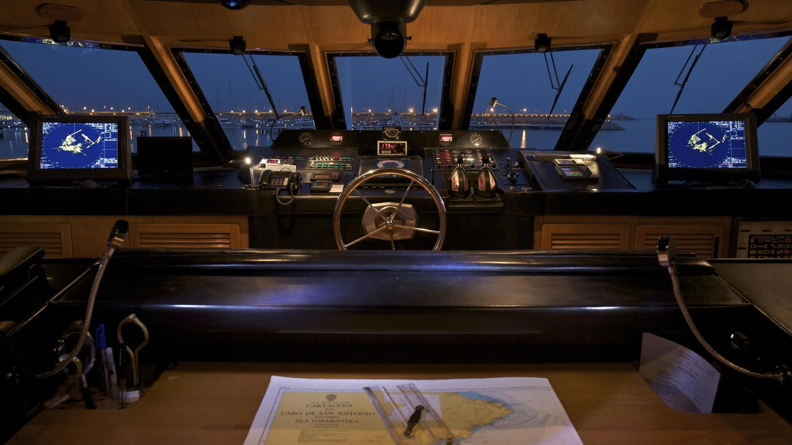 a room with a table and computer screens aboard ACHILLES Yacht for Sale