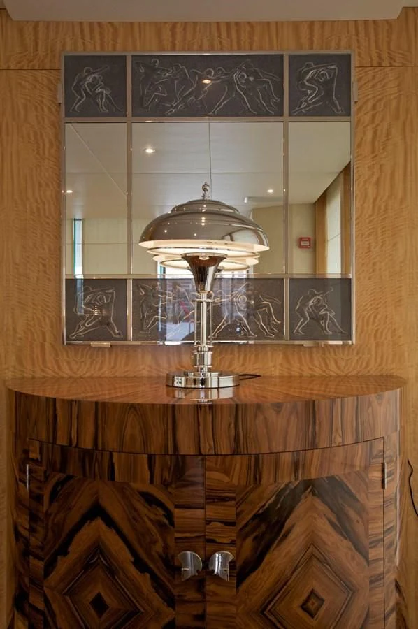 a glass lamp on a wooden surface aboard ACHILLES Yacht for Sale
