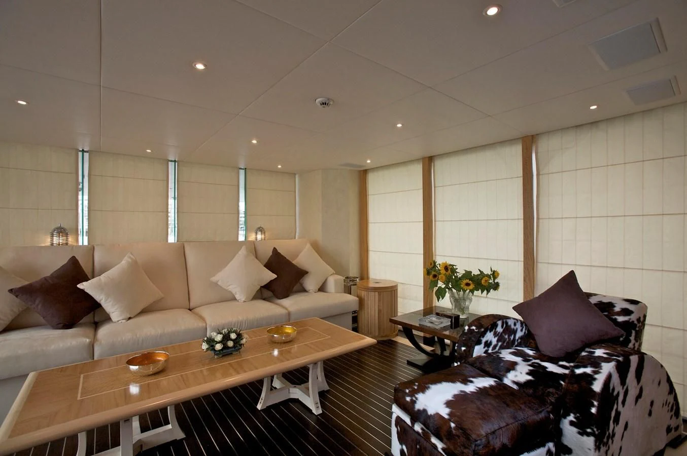 a living room with a couch and a coffee table aboard ACHILLES Yacht for Sale