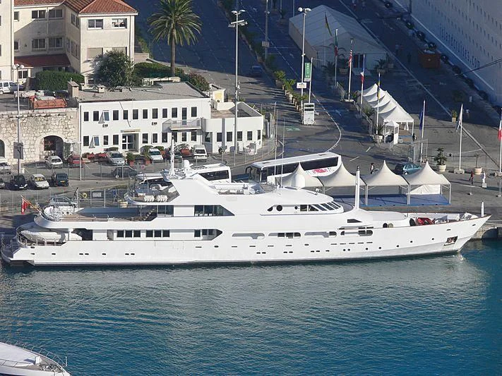 a large white boat in a harbor aboard ACHILLES Yacht for Sale