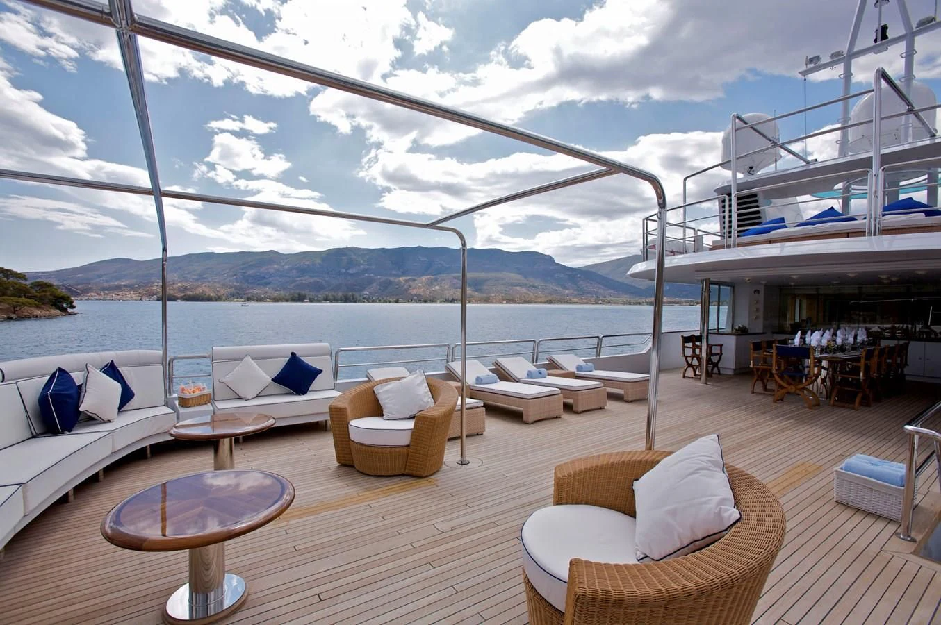 a deck with a view of the ocean and a large ship aboard ACHILLES Yacht for Sale