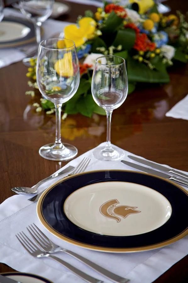 a plate with wine glasses and a plate with food on it aboard ACHILLES Yacht for Sale