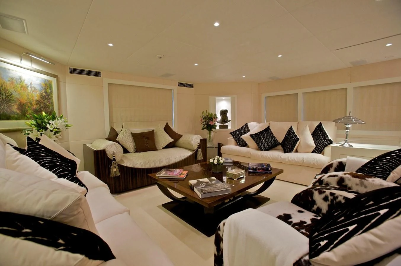 a living room with white couches aboard ACHILLES Yacht for Sale