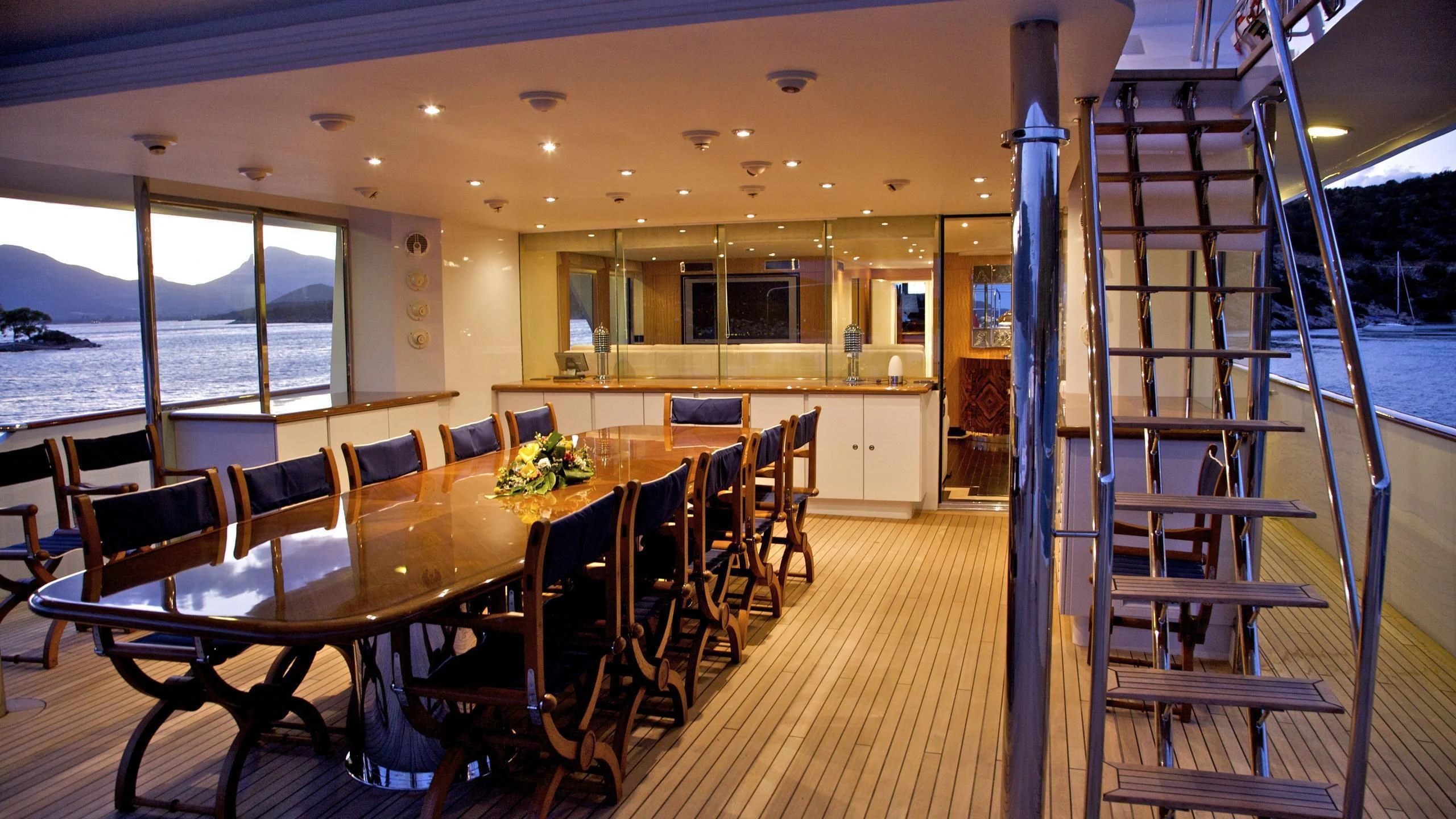 a room with tables and chairs aboard ACHILLES Yacht for Sale