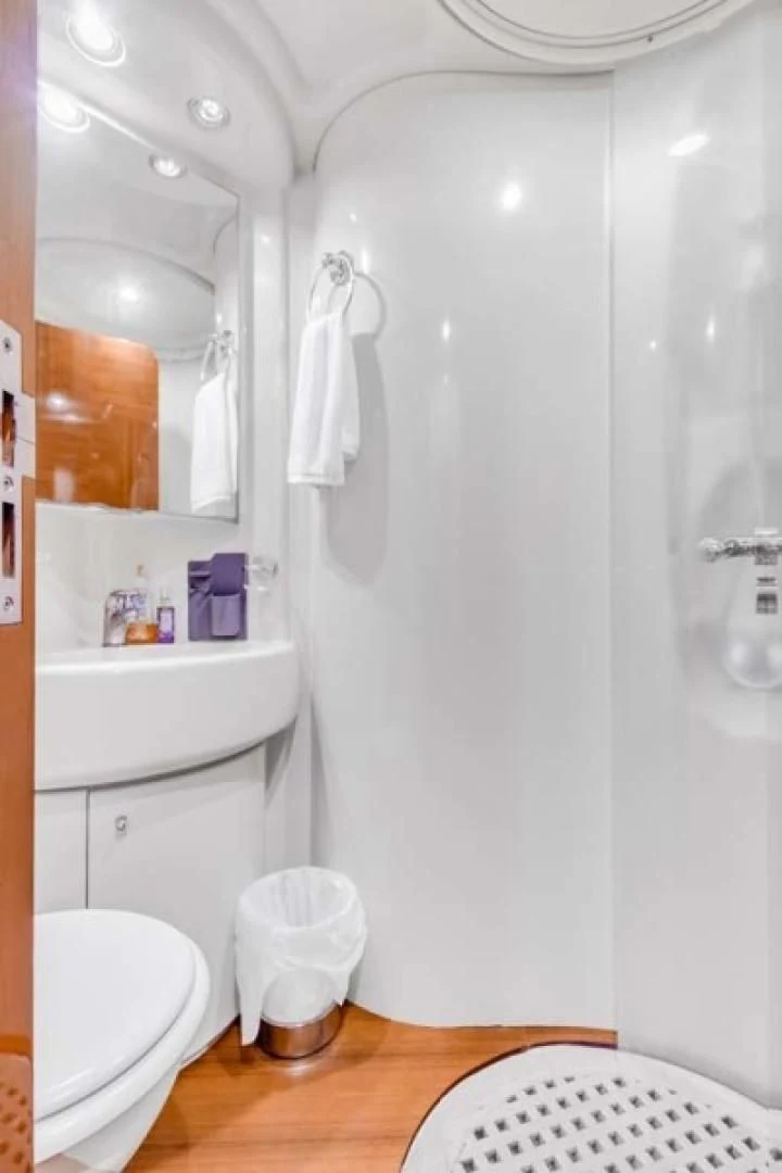 a bathroom with a shower and toilet aboard THE CURE Yacht for Sale