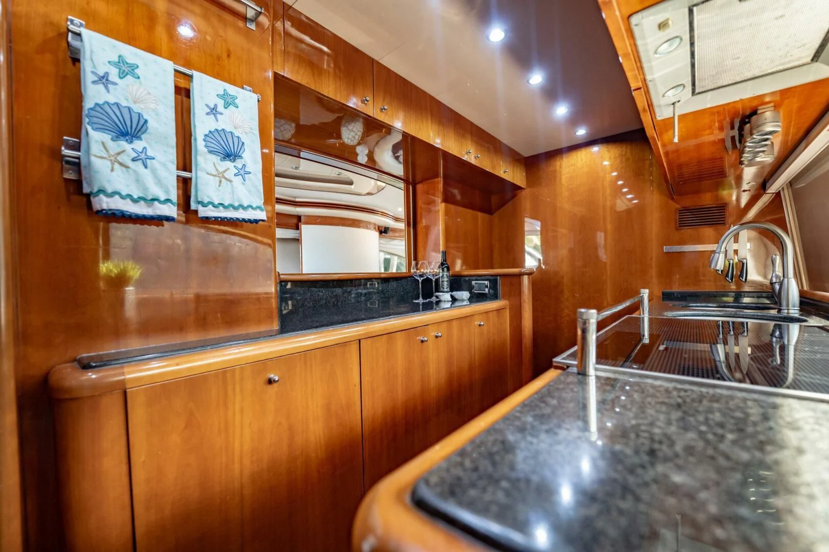 a kitchen with wooden cabinets aboard THE CURE Yacht for Sale