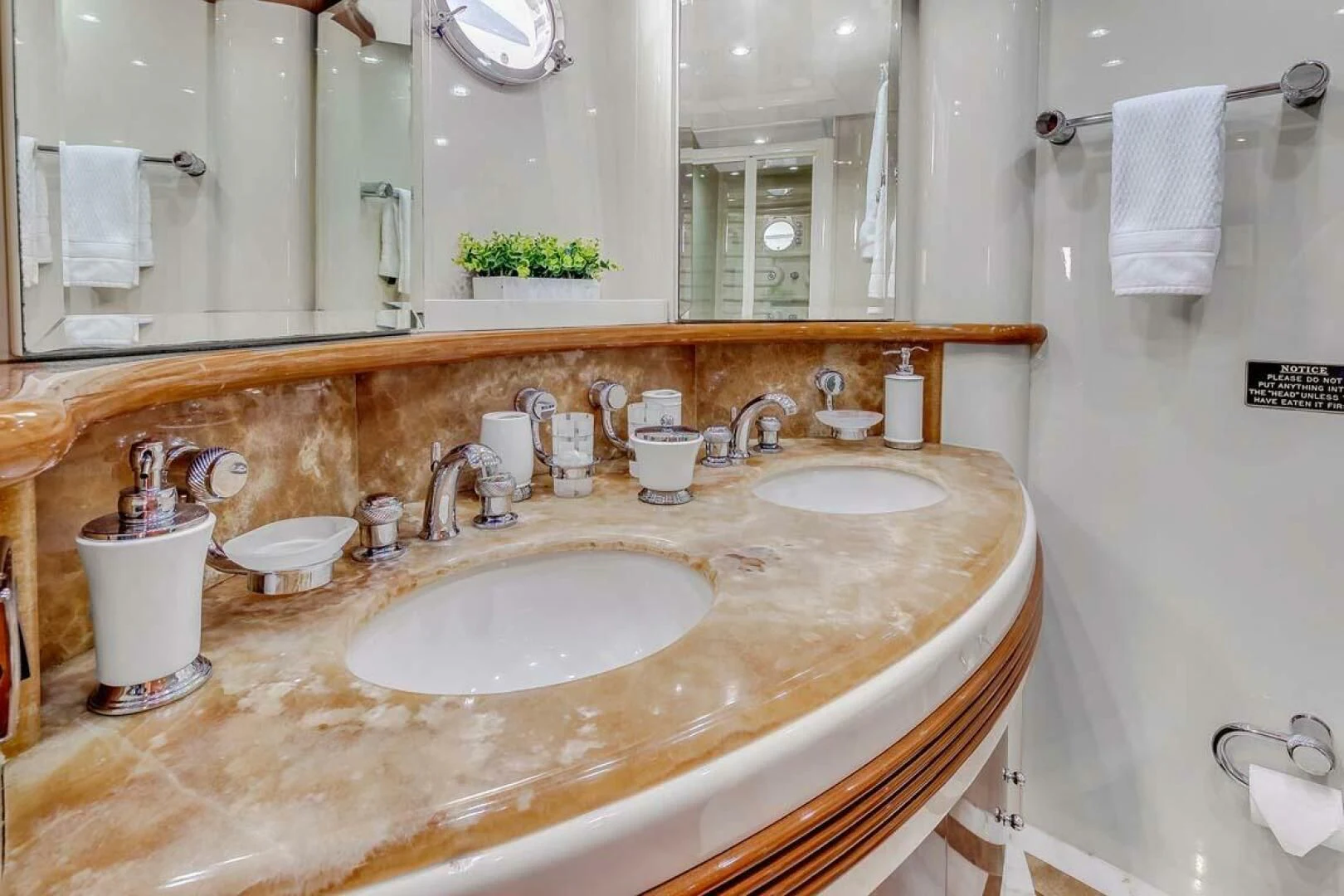 a bathroom with a sink and towels aboard THE CURE Yacht for Sale