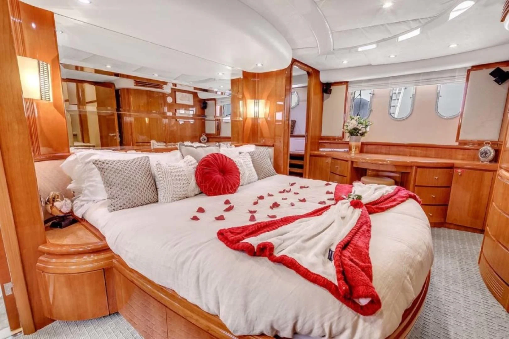 a bed with pink pillows aboard THE CURE Yacht for Sale
