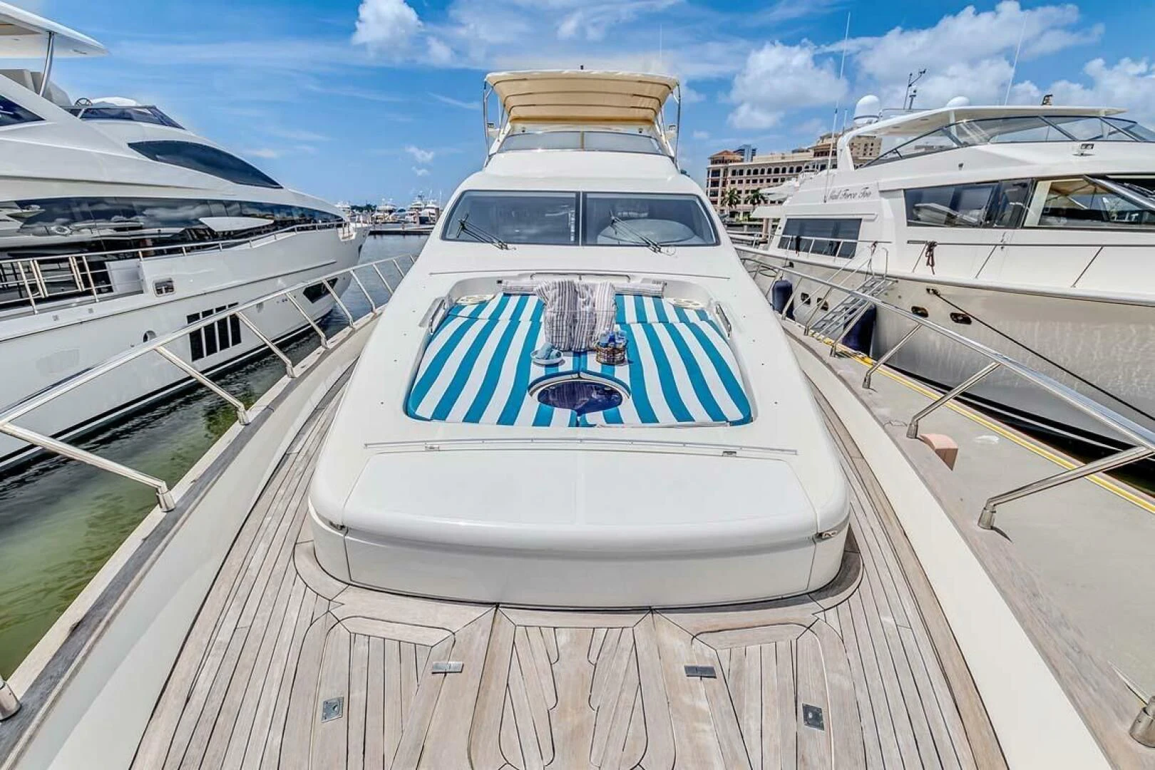 a large white yacht in a harbor aboard THE CURE Yacht for Sale