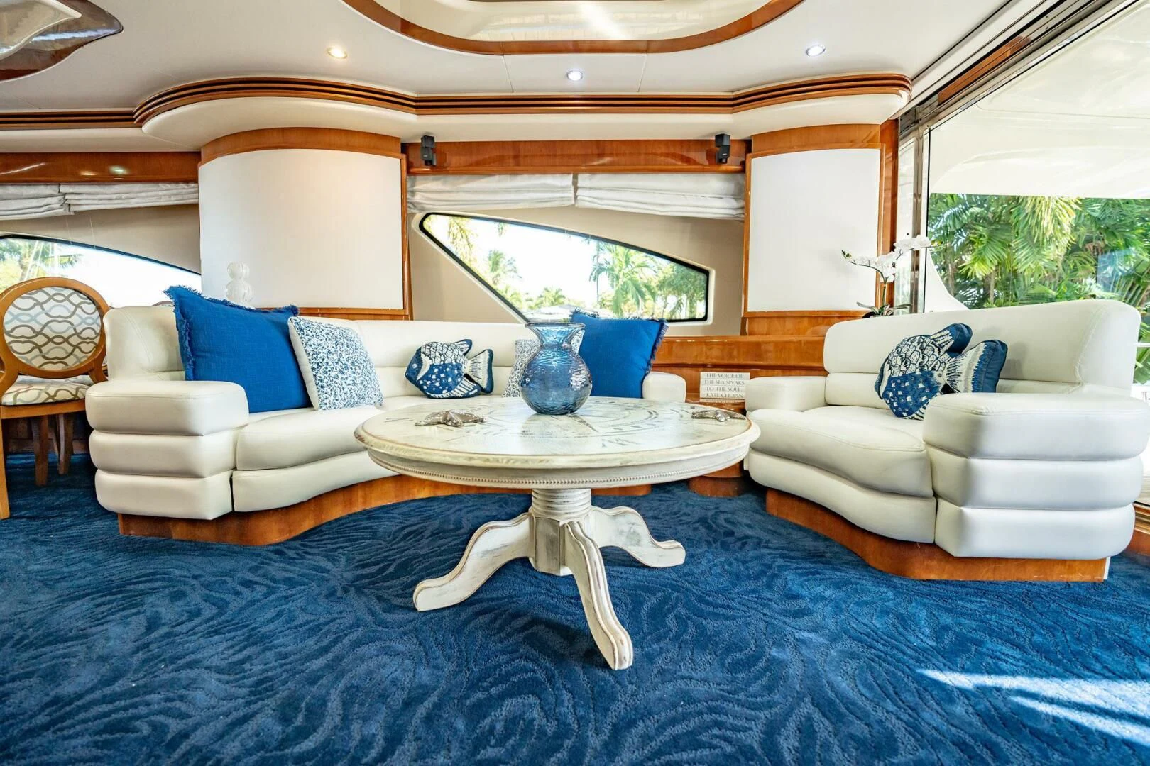 a living room with a blue rug aboard THE CURE Yacht for Sale