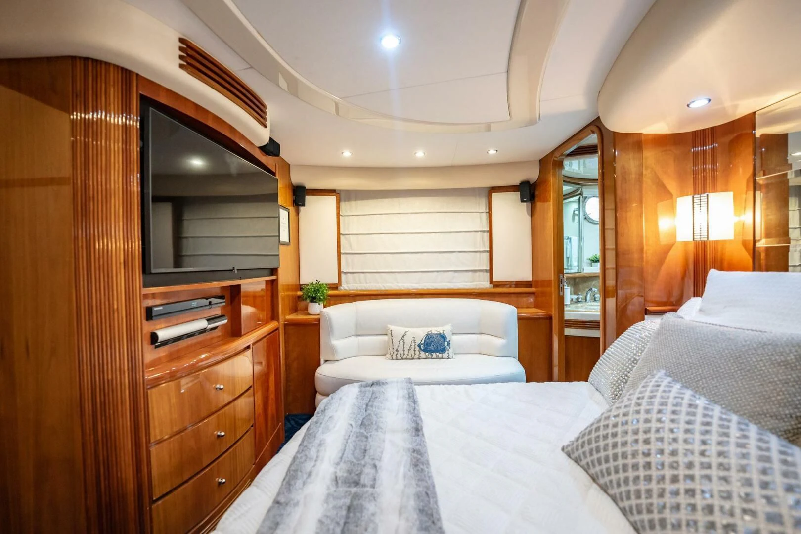a bedroom with a bed and a television aboard THE CURE Yacht for Sale
