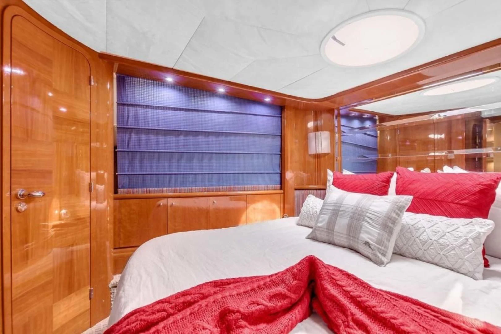 a room with a bed and a wood cabinet aboard THE CURE Yacht for Sale