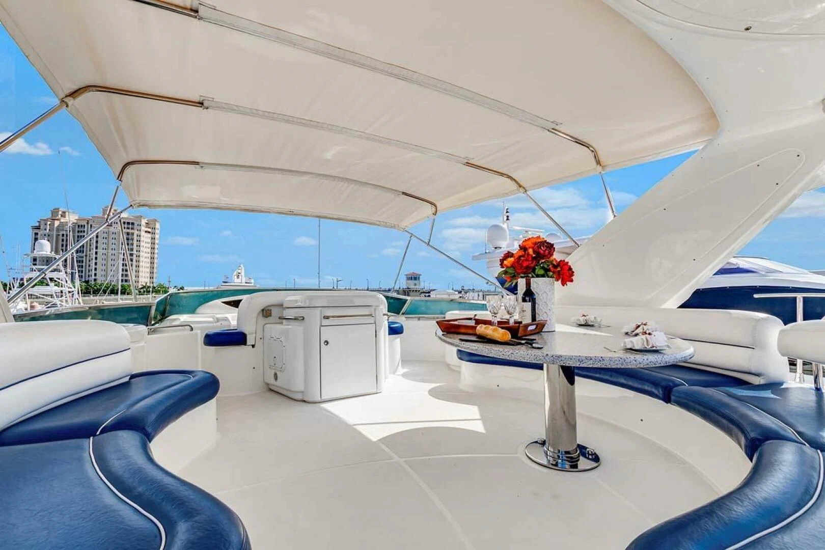 a boat with a table and chairs aboard THE CURE Yacht for Sale