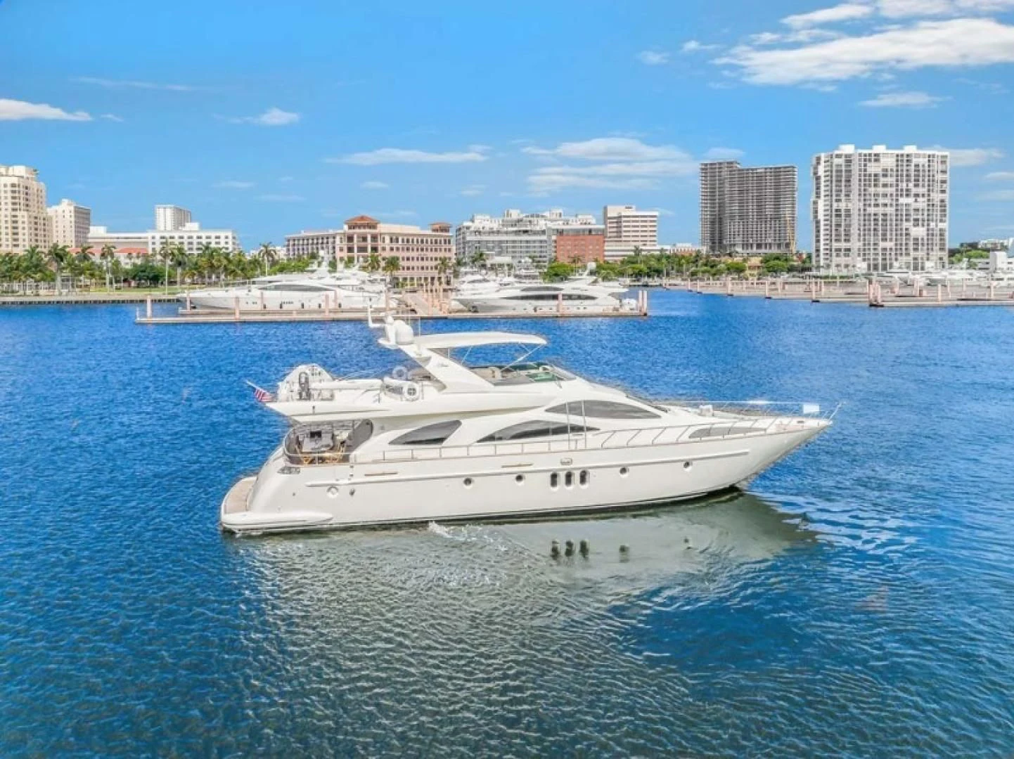 a white yacht in the water aboard THE CURE Yacht for Sale