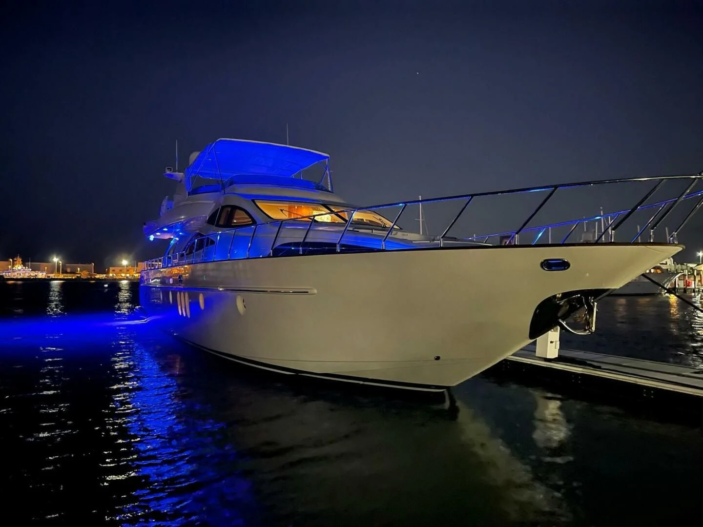 a large white boat on a dock aboard THE CURE Yacht for Sale