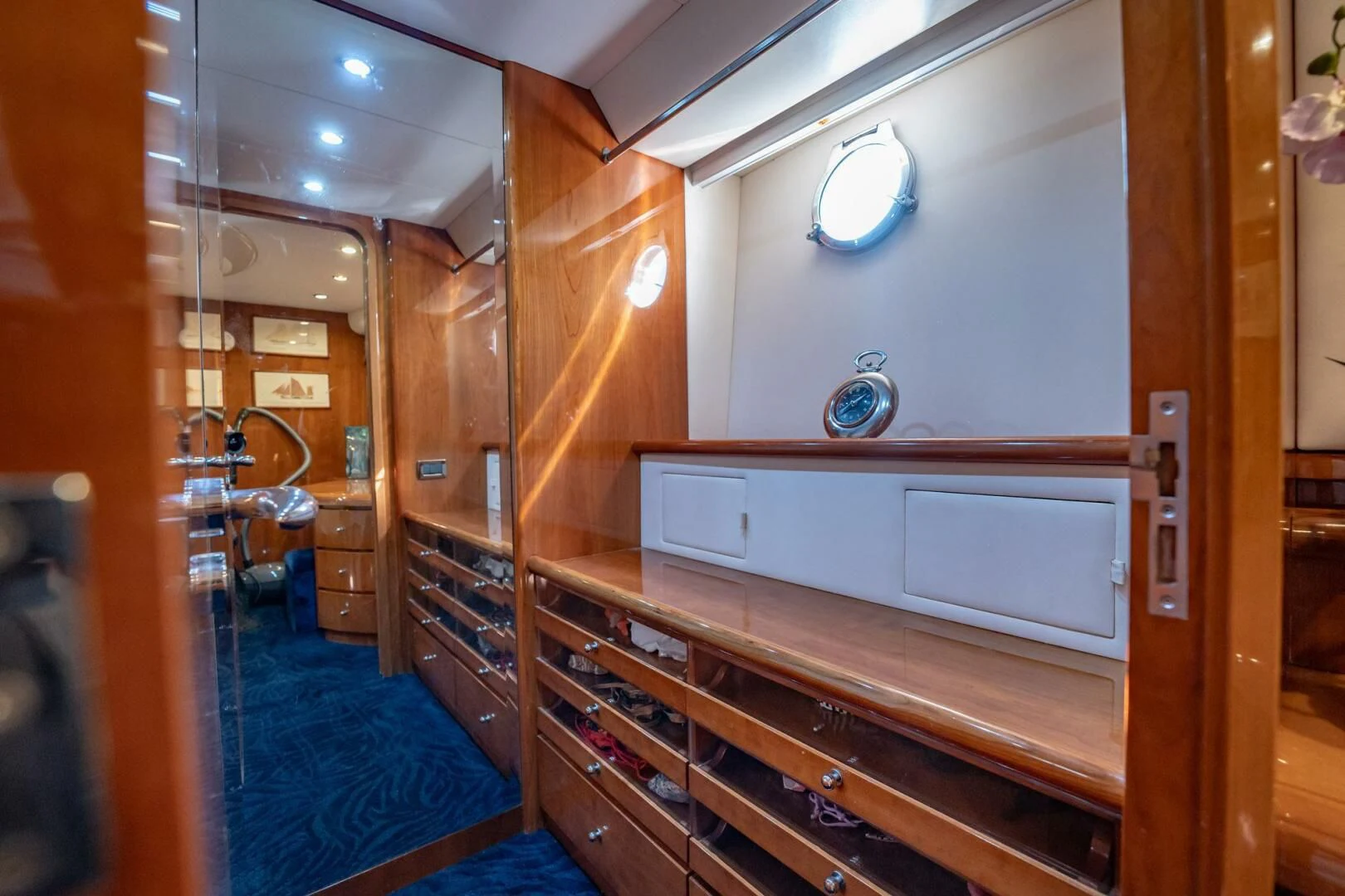 a room with a wood cabinet and a mirror aboard THE CURE Yacht for Sale